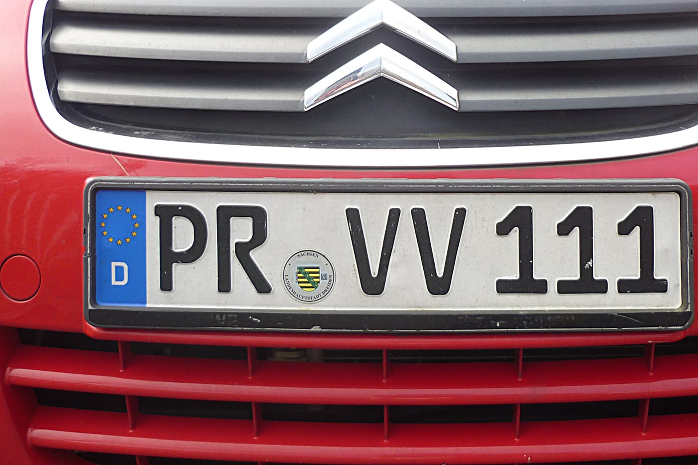 A German number plate on a vehicle, with the round registration seal.
