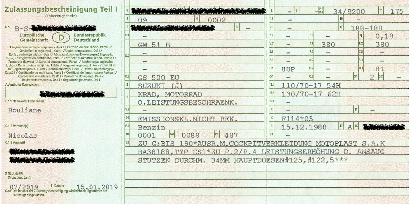The front of a German Zulassungsbescheinigung Teil I. The number plate, vehicle identification number and address are blacked out. The security code is on the back and is not visible here.