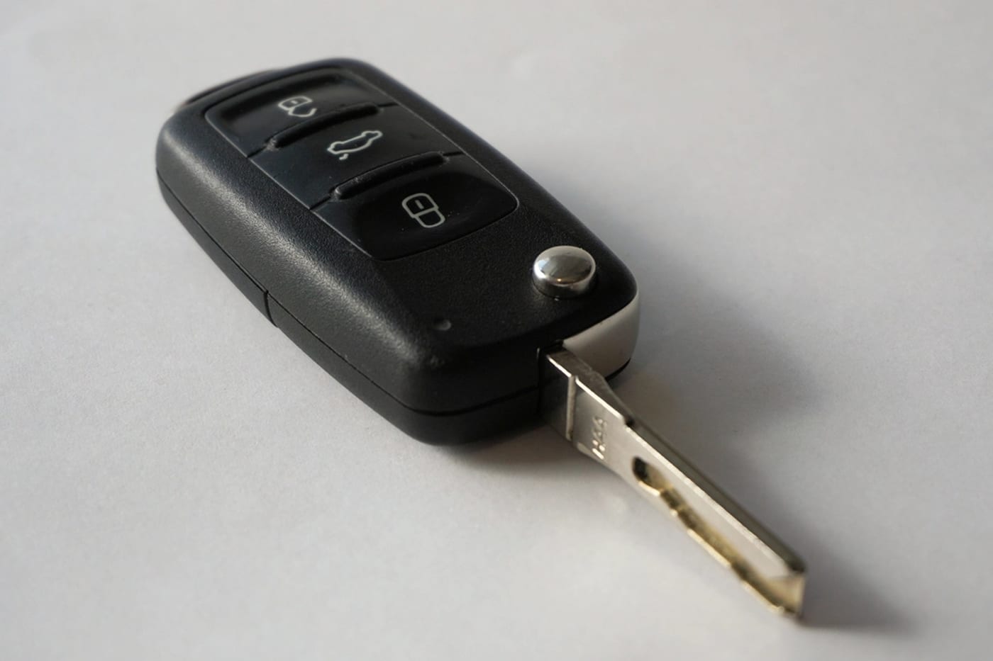 A car key on a light surface.